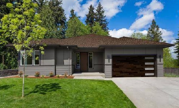 Home exterior featuring a dark grey garage door with dark trim.