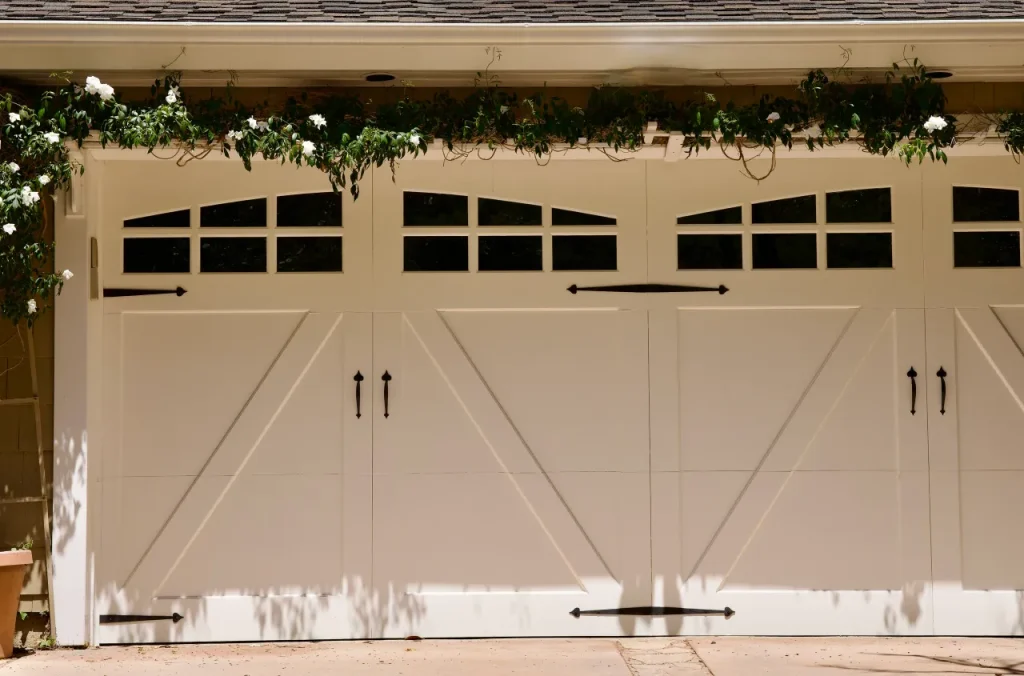 Traditional white raised-panel garage door with arched windows.